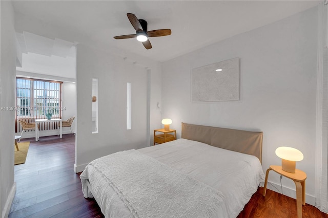 bedroom featuring ceiling fan and dark wood-type flooring