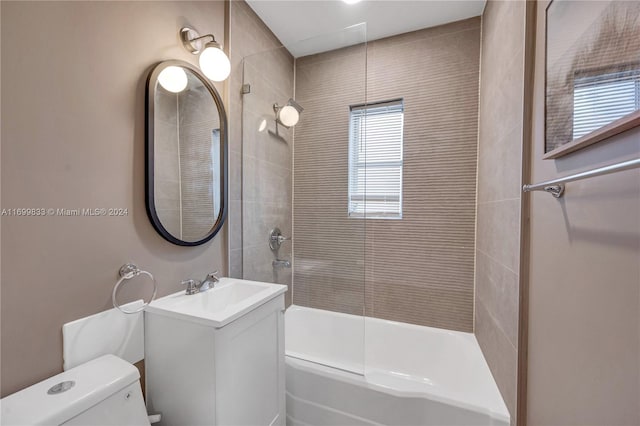 full bathroom with vanity, toilet, and tiled shower / bath