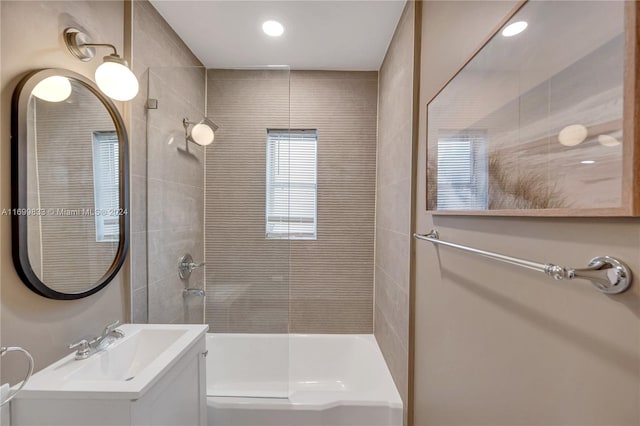 bathroom featuring vanity and tiled shower / bath combo