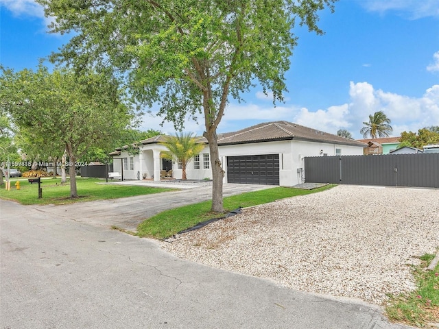 ranch-style house featuring a garage and a front lawn