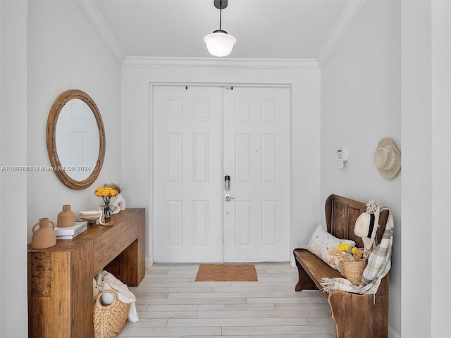 foyer with light hardwood / wood-style flooring and crown molding