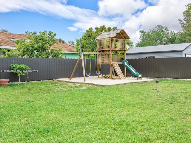 view of playground with a lawn