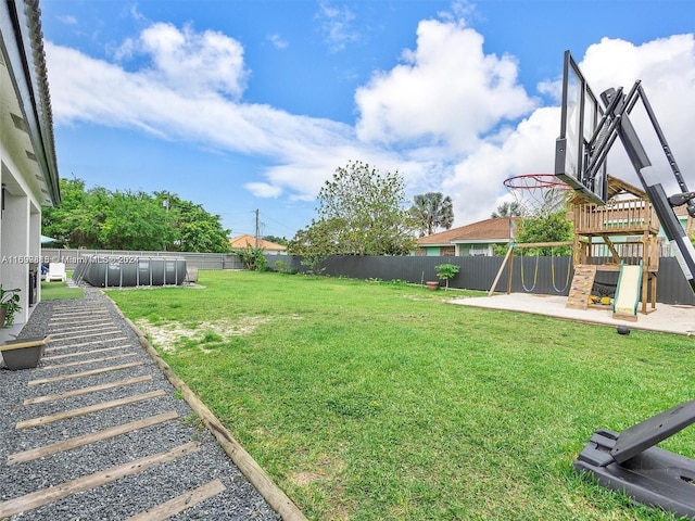 view of yard featuring a playground and a swimming pool