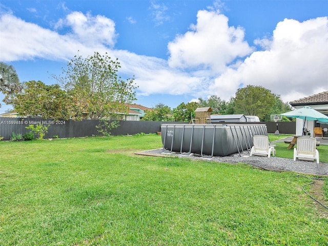 view of yard with a gazebo and a fenced in pool