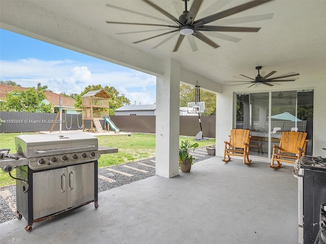 view of patio / terrace featuring a playground, grilling area, and ceiling fan