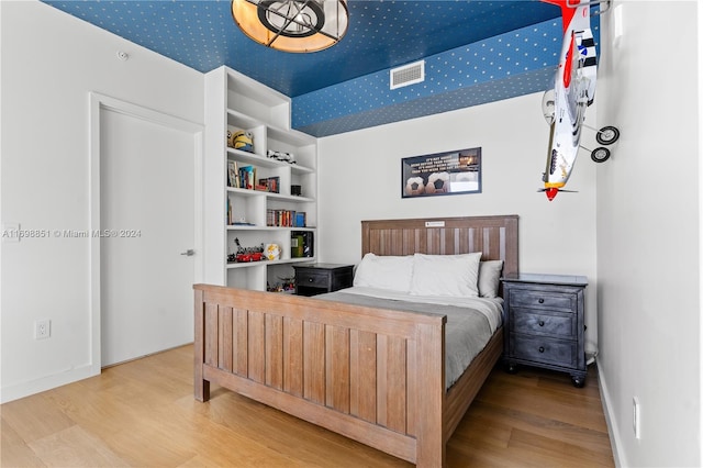 bedroom with wood-type flooring