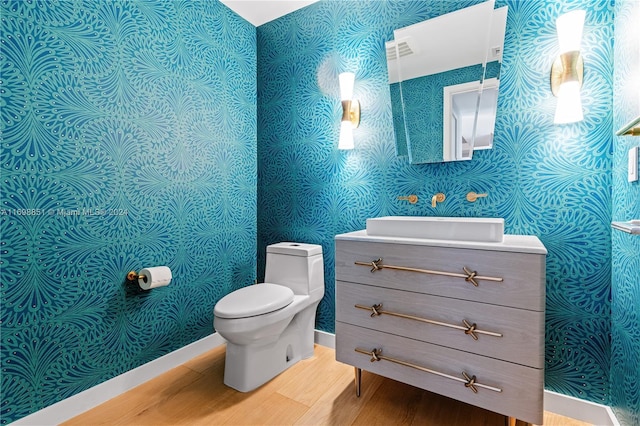 bathroom featuring hardwood / wood-style floors, vanity, and toilet