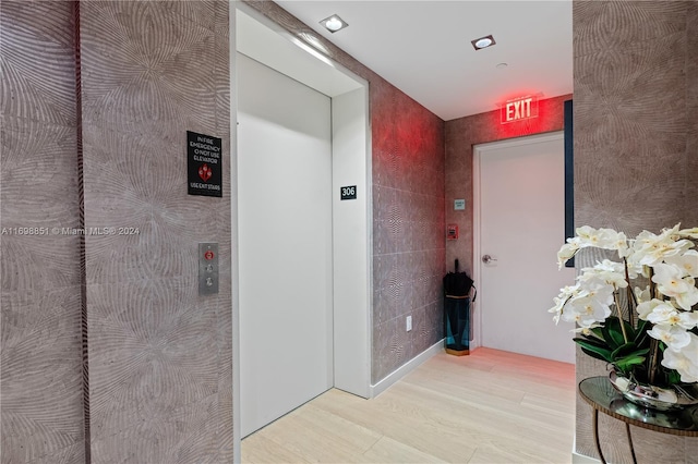 corridor with light wood-type flooring