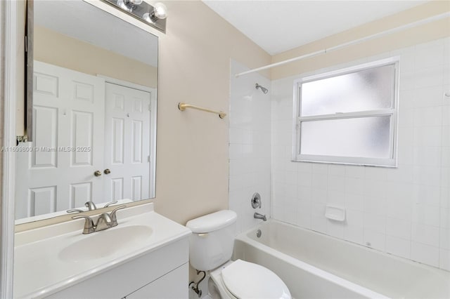 full bathroom with toilet, vanity, and tiled shower / bath combo