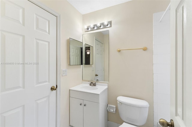 bathroom with toilet and vanity