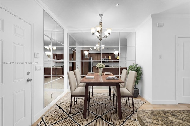 dining area featuring a chandelier, hardwood / wood-style floors, and ornamental molding