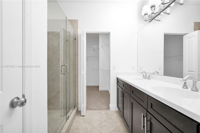 bathroom with tile patterned floors, vanity, and an enclosed shower