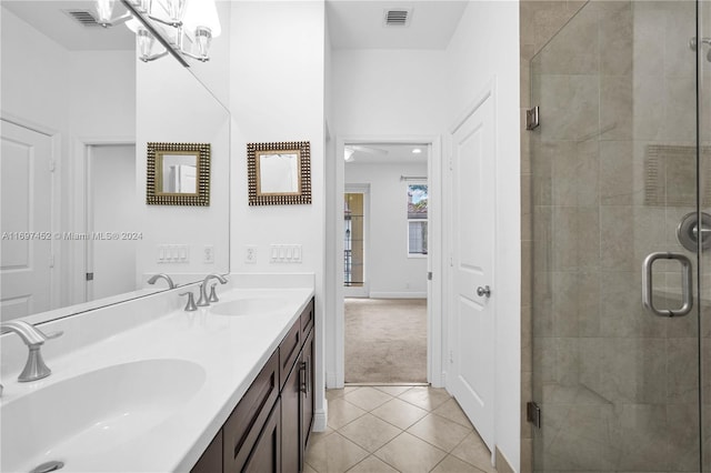 bathroom with tile patterned floors, vanity, ceiling fan, and a shower with shower door