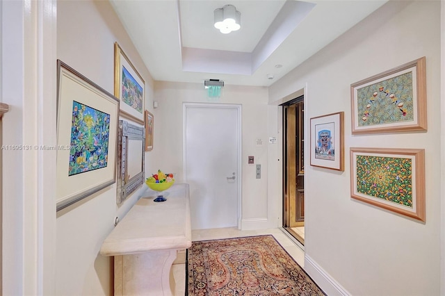 entryway featuring a raised ceiling