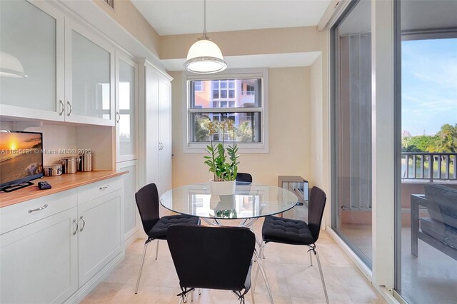 kitchen with light tile patterned flooring, appliances with stainless steel finishes, sink, and white cabinets