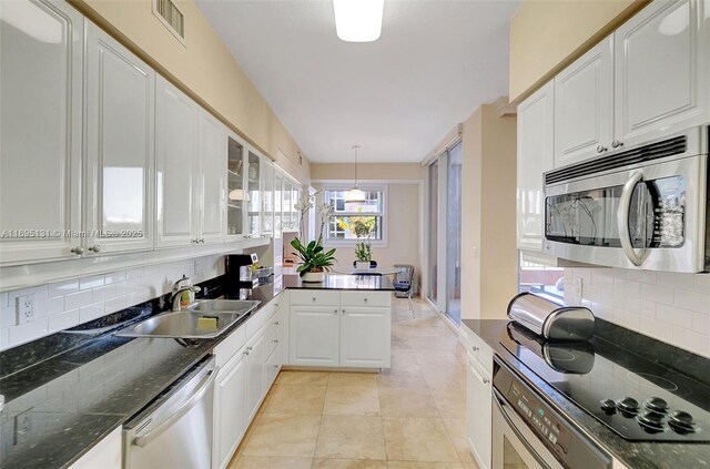 entryway with elevator and a raised ceiling