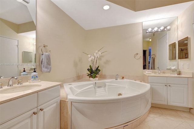 bathroom featuring tile patterned flooring, vanity, and a bathtub