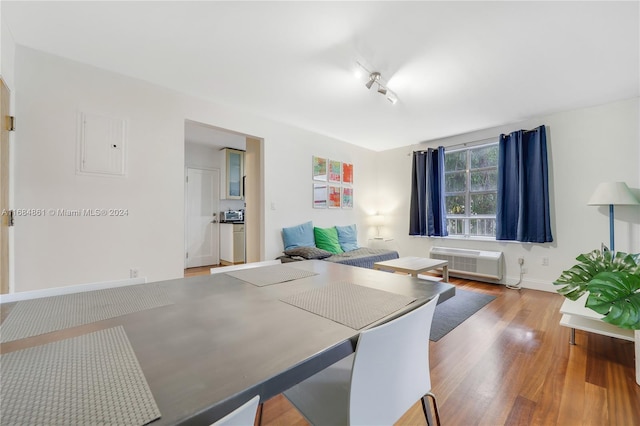 420 15th St Unit 105, Miami Beach, FL 33139 - dining space featuring a wall mounted air conditioner, wood finished floors, and baseboards
