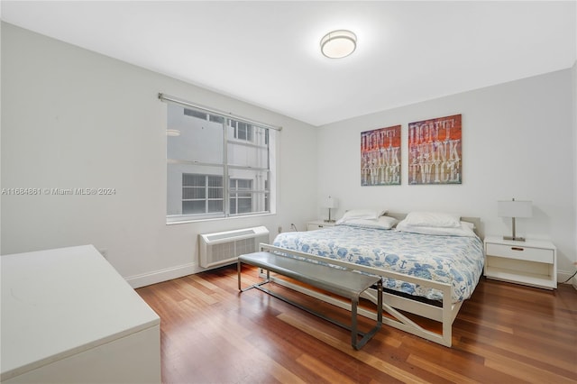 420 15th St Unit 105, Miami Beach, FL 33139 - bedroom with a wall mounted AC, wood finished floors, and baseboards