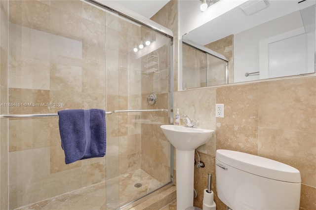 420 15th St Unit 105, Miami Beach, FL 33139 - bathroom with toilet, a shower stall, tile walls, and a sink