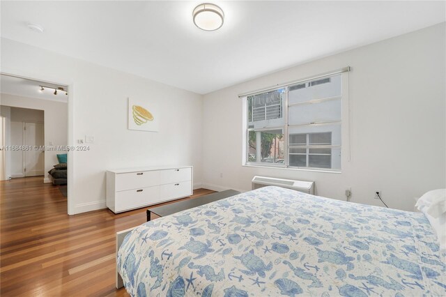 bedroom with hardwood / wood-style floors