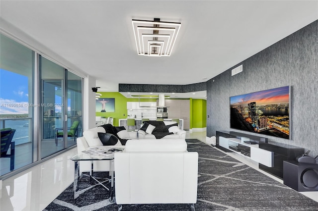 living room with a water view and a wall of windows