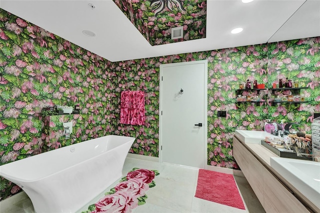 bathroom featuring vanity, tile patterned flooring, and a relaxing tiled tub