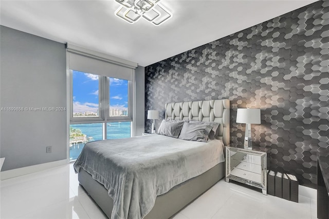 tiled bedroom with a water view