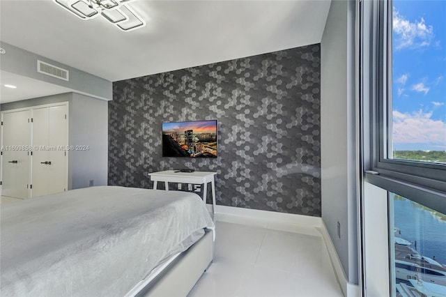 bedroom featuring a closet and light tile patterned flooring