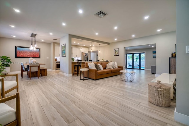 living room with light hardwood / wood-style floors and french doors