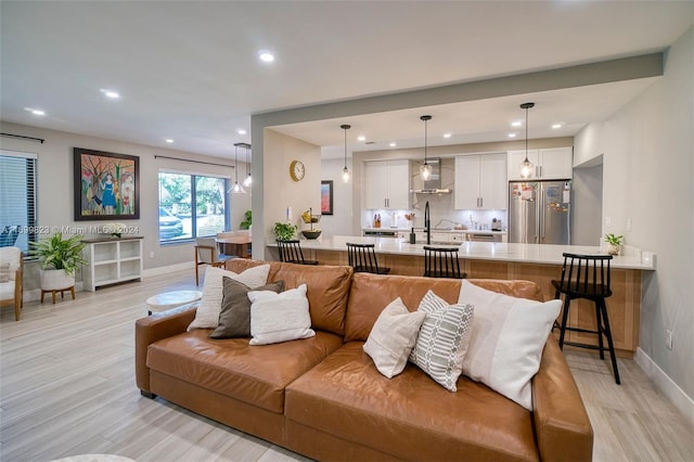 living room featuring light hardwood / wood-style floors and sink