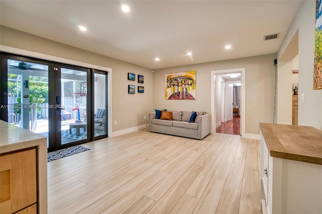 living room featuring light wood-type flooring and french doors