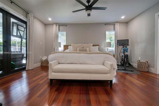 bedroom featuring dark hardwood / wood-style flooring, multiple windows, and ceiling fan