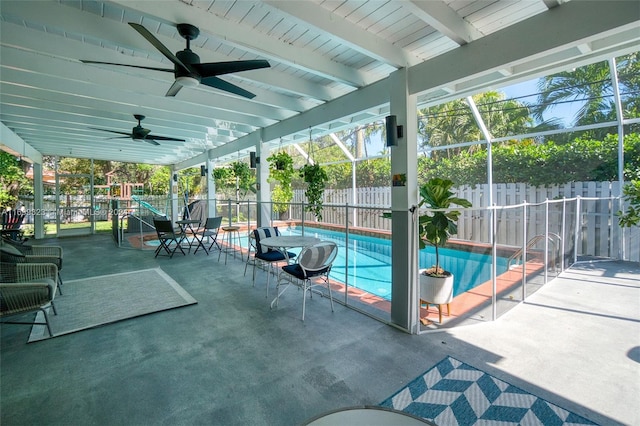 view of swimming pool with glass enclosure, a patio area, and a playground