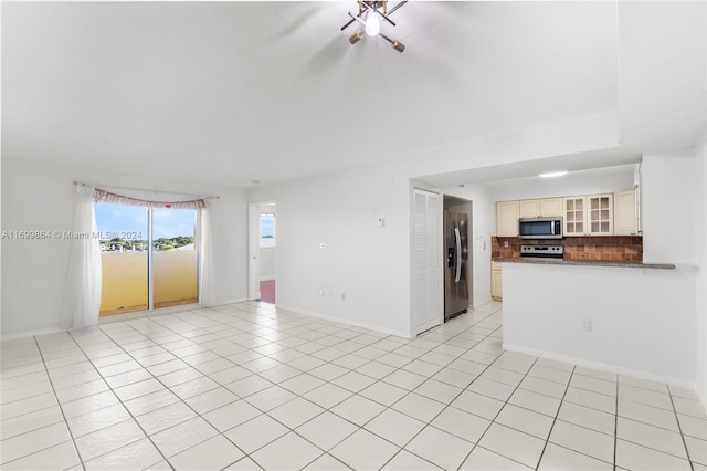 unfurnished living room with light tile patterned flooring