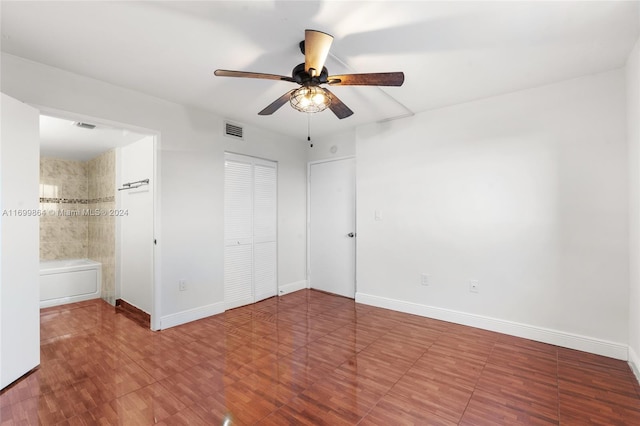 unfurnished bedroom featuring ceiling fan and connected bathroom