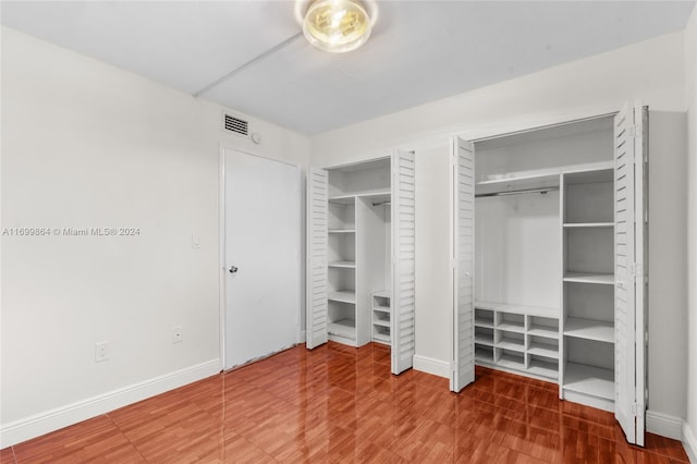 unfurnished bedroom featuring hardwood / wood-style flooring