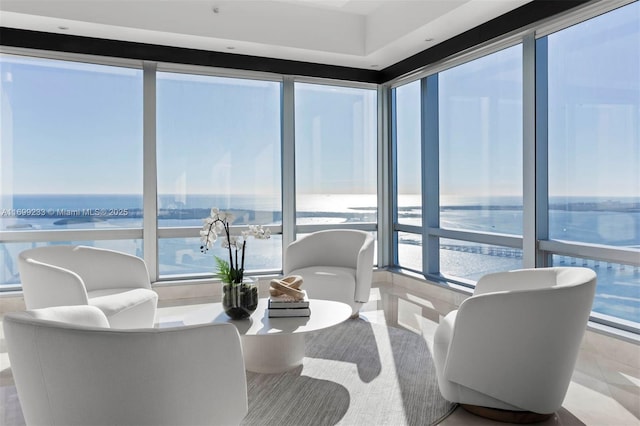 sunroom with a water view and a healthy amount of sunlight