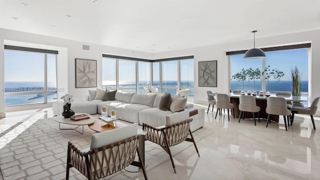 living room with a wealth of natural light and a water view