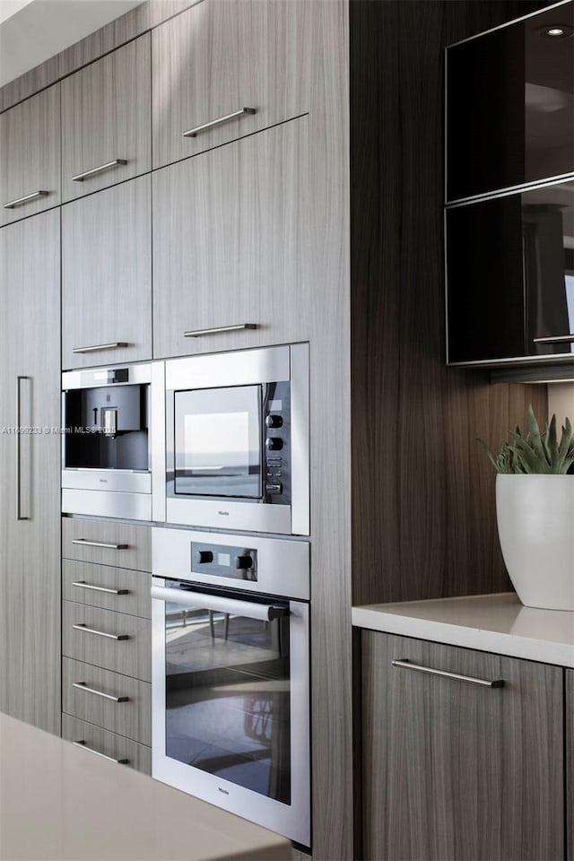 kitchen featuring light brown cabinetry and appliances with stainless steel finishes