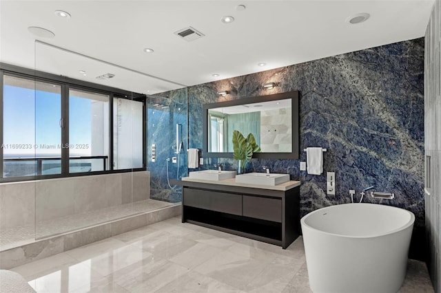 bathroom with shower with separate bathtub, tile walls, and vanity