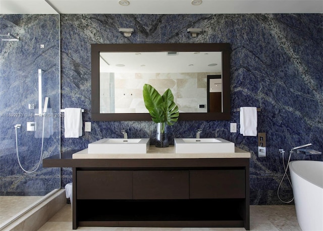 bathroom with vanity, shower with separate bathtub, and tile walls