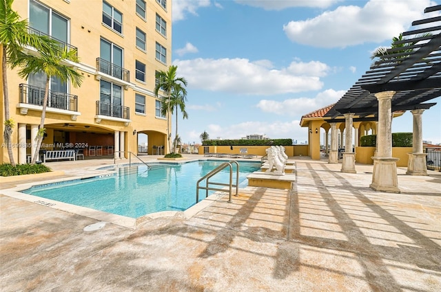 view of swimming pool with a pergola and a patio