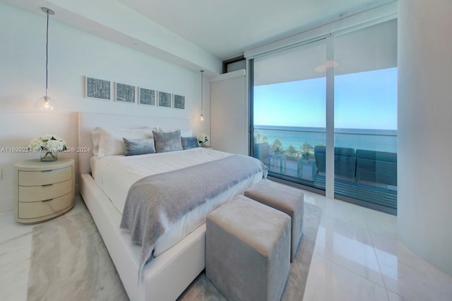 tiled bedroom featuring access to exterior, a water view, and a wall of windows