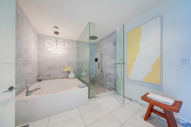 bathroom with shower with separate bathtub and an inviting chandelier