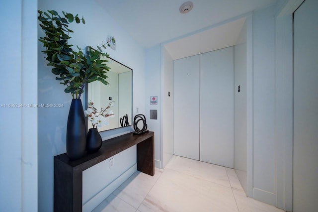 corridor with light tile patterned floors