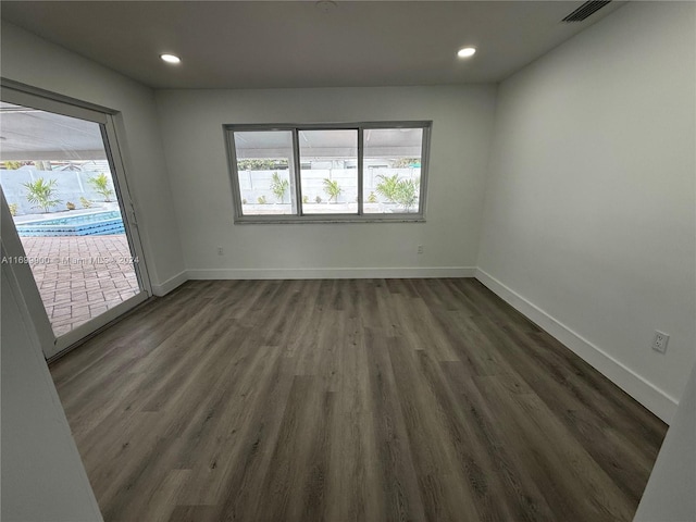 spare room with dark hardwood / wood-style flooring