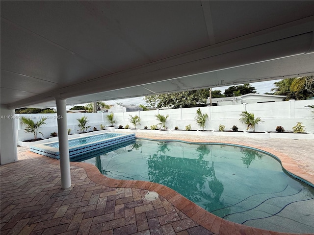 view of swimming pool with a patio area and a jacuzzi