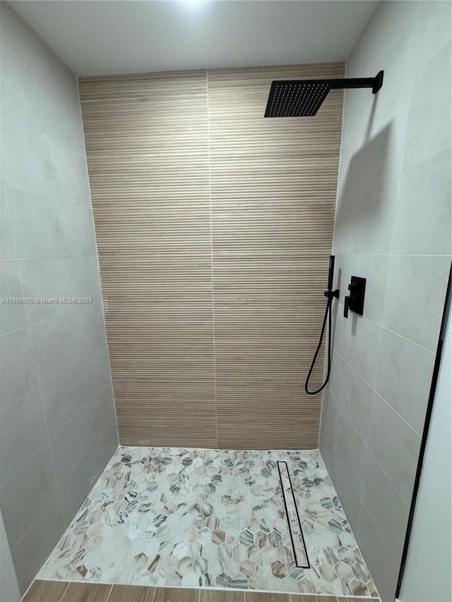 bathroom with a tile shower