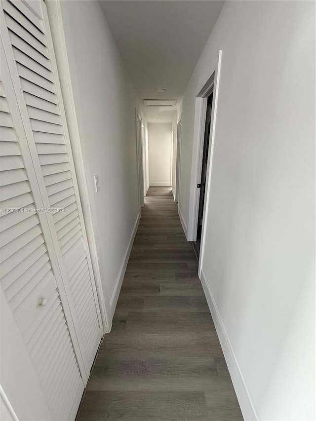 hallway with dark hardwood / wood-style flooring